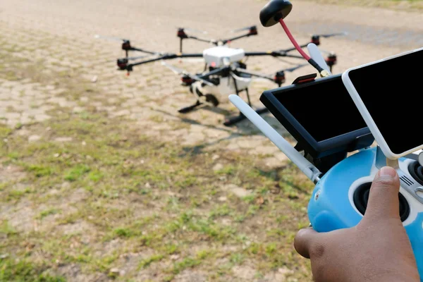 man controlling agriculture drone. remote controller