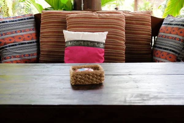 Pillow on wooden settee bench on terrace patio near garden — Stock Photo, Image