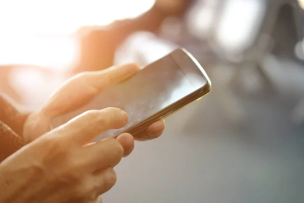 hand holding mobile smart phone at airport