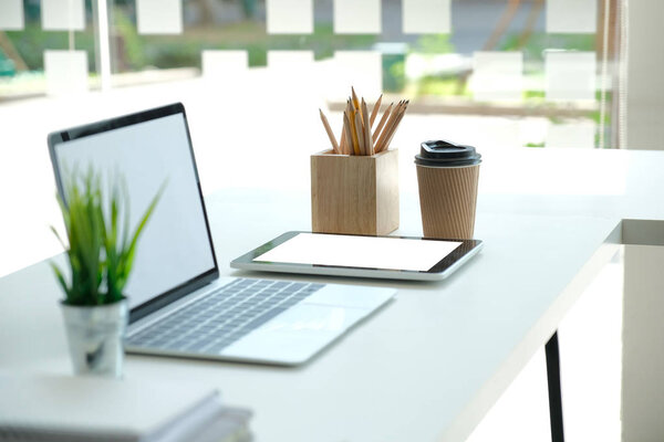 computer tablet pencil coffee cup on office desk. workplace inte