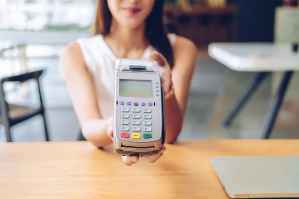 woman with credit card swiping machine. shopping lifestyle & pay