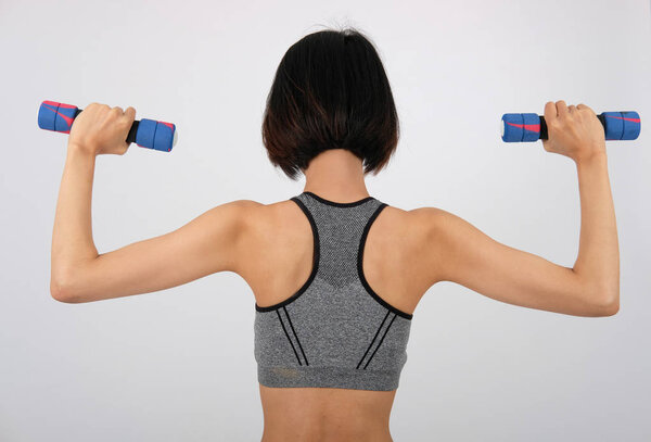 sporty woman in sportswear with dumbbell doing fitness workout o