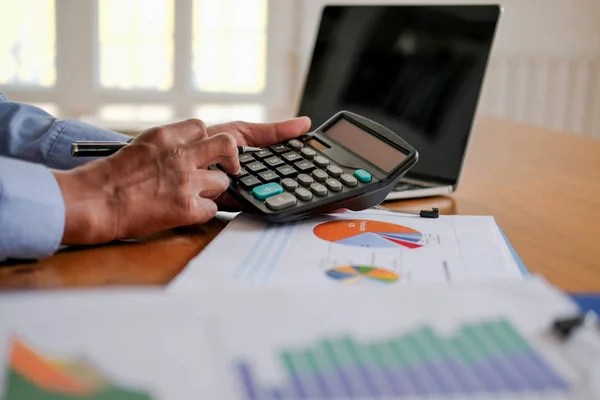 financial adviser use calculator to calculate revenue & budget.