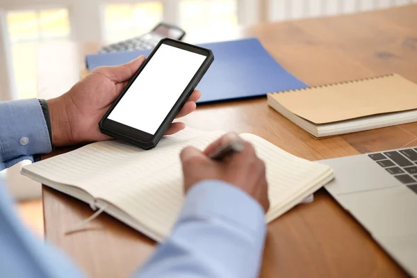 man writing note on notebook. businessman working organizing pla