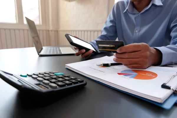 man holding credit card using smart phone for online shopping. b