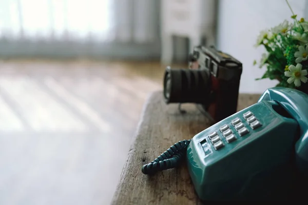 vintage old telephone camera on wooden desk