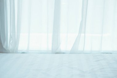 Yanındaki beyaz şilte perdenin arkasını görüyor.