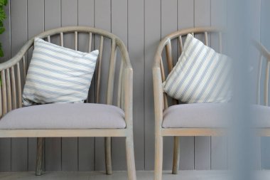 Oturma odasındaki tahta koltukta çizgili yastık. ev içi