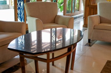 Oturma odasındaki bej yastıklı koltuk. ev içi