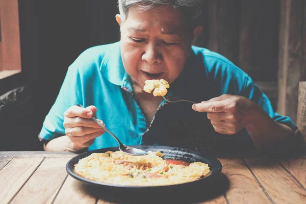 old asian elderly senior elder woman eating food at restaurant. mature retirement lifestyle