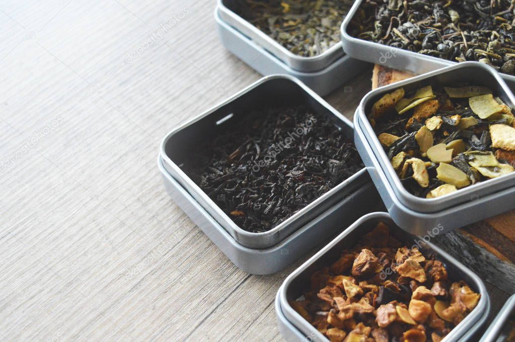 Different types of loose teas. Black tea with orange, green with fruits, clean green tea and fruit tea and green tea with almonds and raisins.