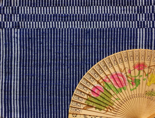 vintage Chinese wood fan on table cloth