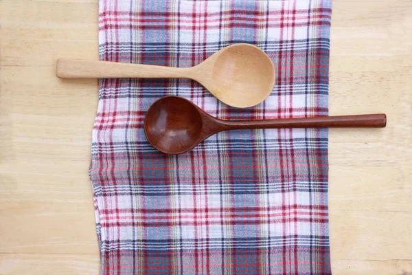 wood spoon with plaid on wood background