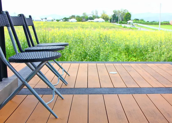 living seat on wood terrace with farmland background