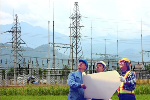 the electrical engineer group are inspection  the power transmission system with power plant background