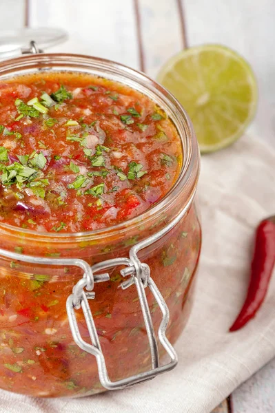Tomato salsa in a glass jar. — Stock Photo, Image