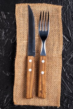 Siyah arka planda ahşap çatal bıçak..