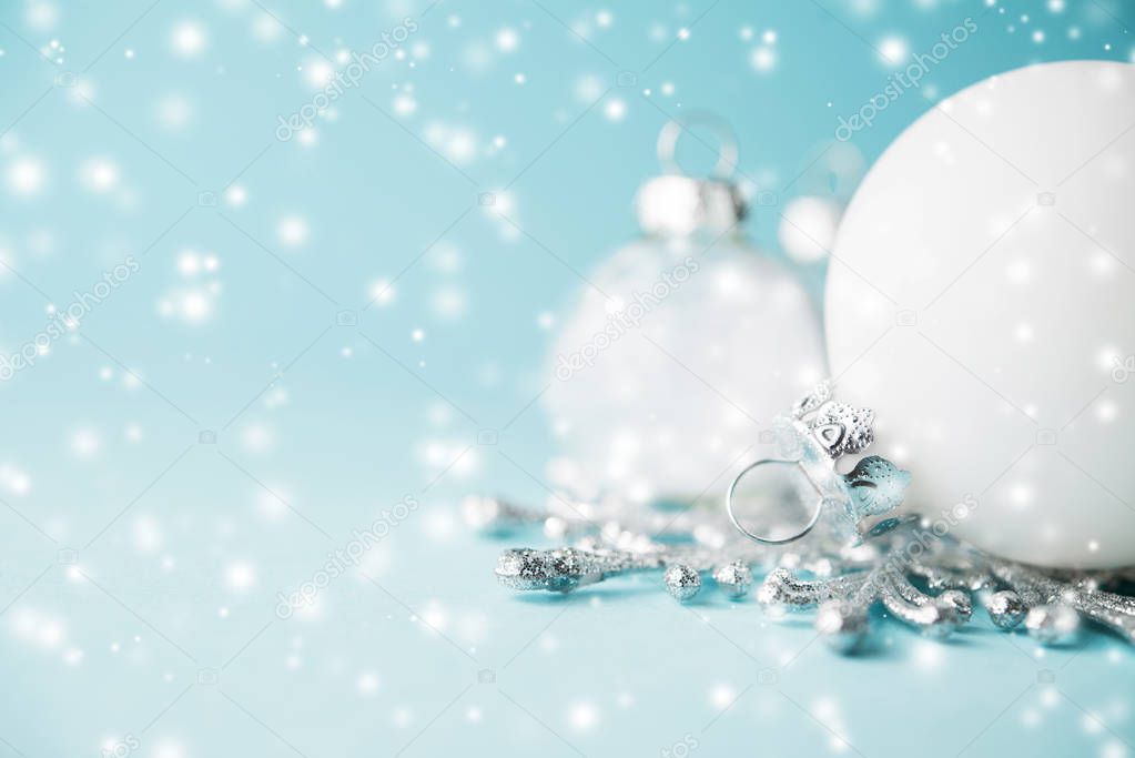 White xmas ornaments on light blue background. Merry christmas card