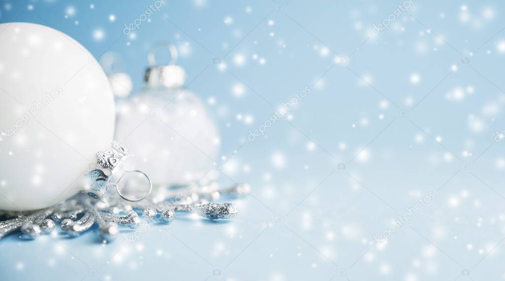 White xmas ornaments on light blue background. Merry christmas card