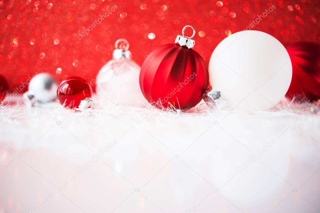 White, red and silver Christmas decorations on red glitter background