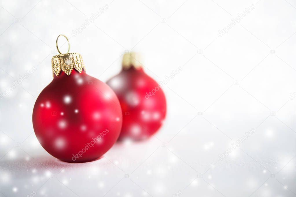 Red Christmas balls on silver bokeh background