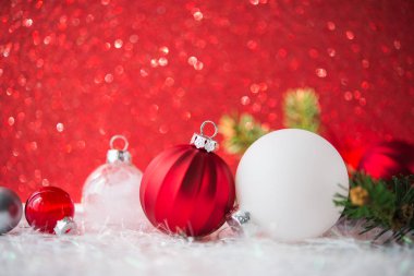 Kırmızı parlak zemin üzerine beyaz, kırmızı ve gümüş Noel süsleri
