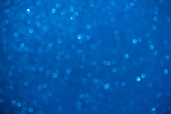 Unfocused abstract blue glitter background