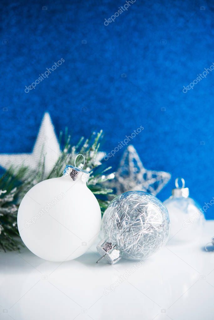 White and silver Christmas decorations on blue background