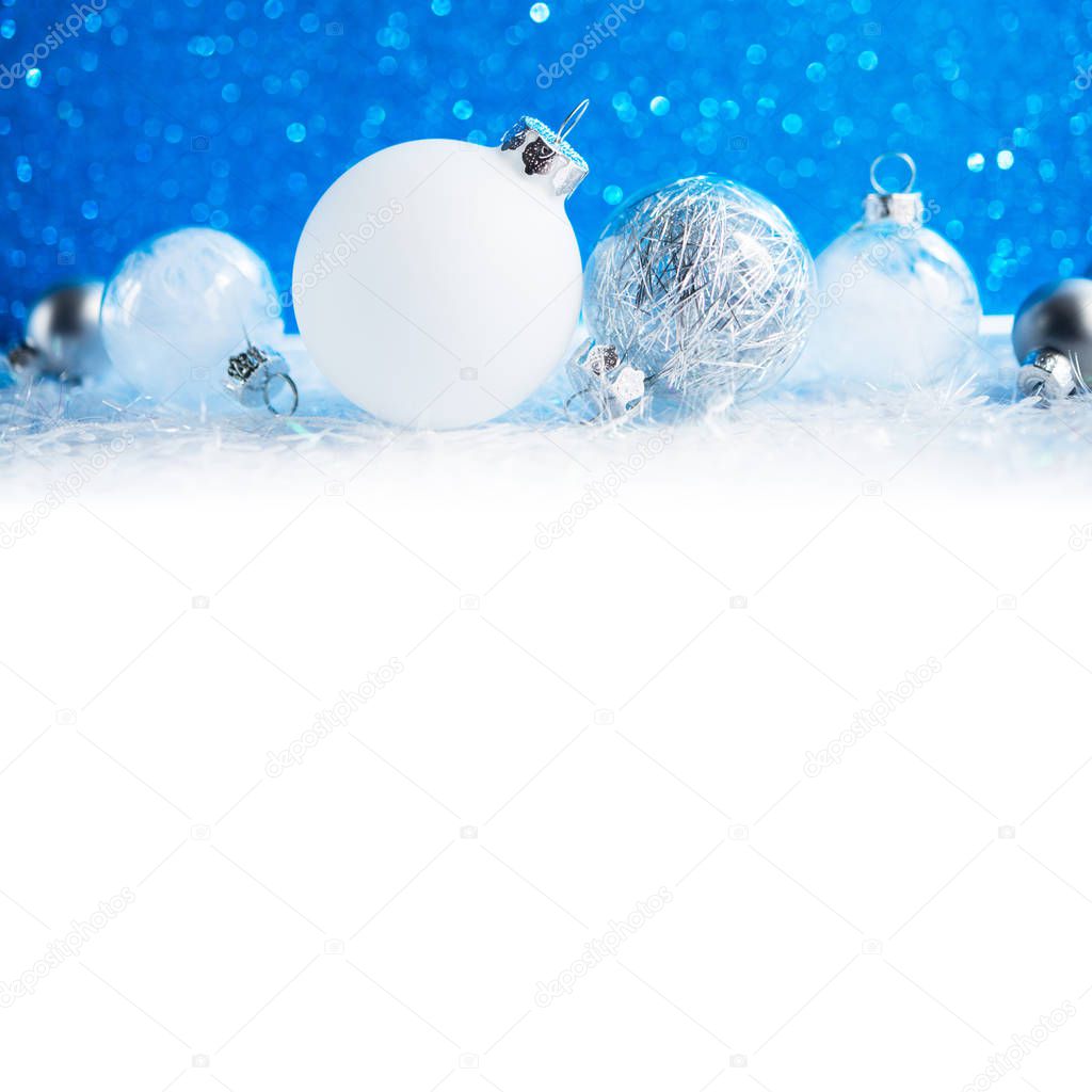 White and silver Christmas decorations on blue background