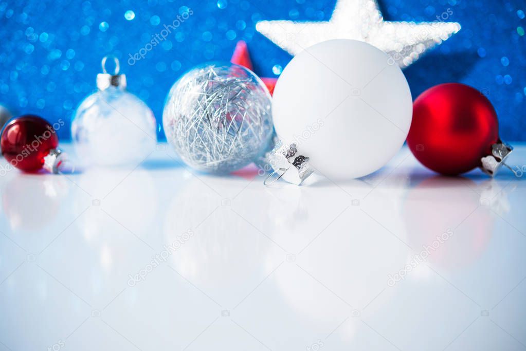 White, red and silver Christmas decorations on blue background