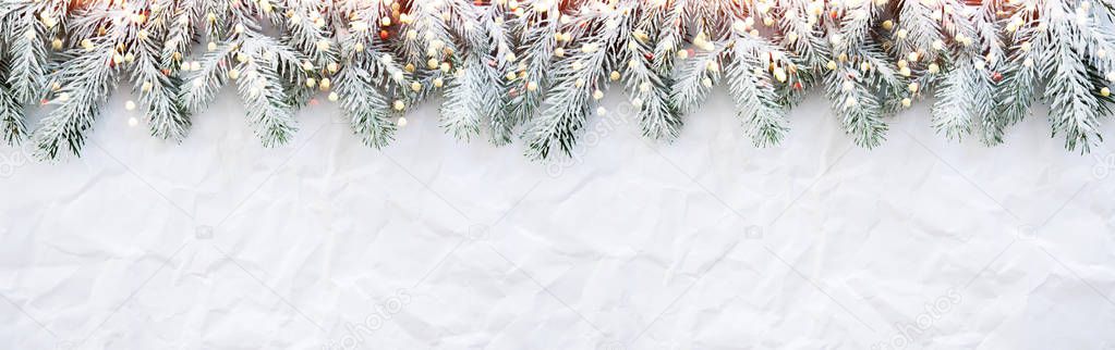 Christmas background with xmas tree on white creased background.