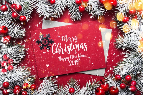 Merry Christmas and Happy Holidays greeting card, frame, banner. New Year. Noel. Christmas ornaments, envelope cover and fir tree on red background top view. Winter holiday theme. Flat lay.