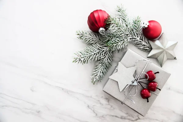 Christmas silver handmade gift boxes on white marble background top view. Merry Christmas greeting card, frame. Winter xmas holiday theme. Happy New Year. Noel. Flat lay