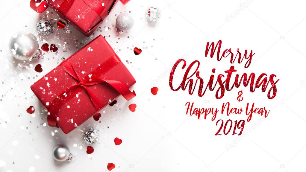 Merry Christmas and Happy Holidays greeting card, frame, banner. New Year. Christmas red gifts, presents on white background top view. Winter holiday theme. Noel. Flat lay.