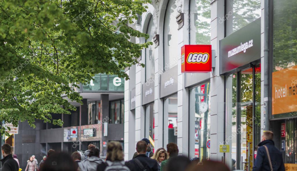 Crowds of people walk past the Lego store in downtown Prague
