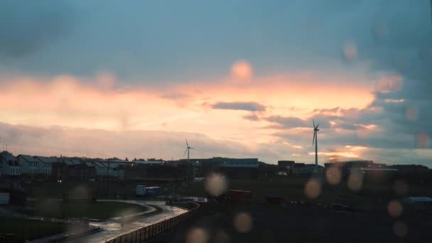 A rainy timelapse of rain clouds over England with water drops on the window clearning up over hours. — Stock Video