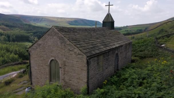 4k antenne van het prachtige Peak District National Park van achter een oude kerk — Stockvideo