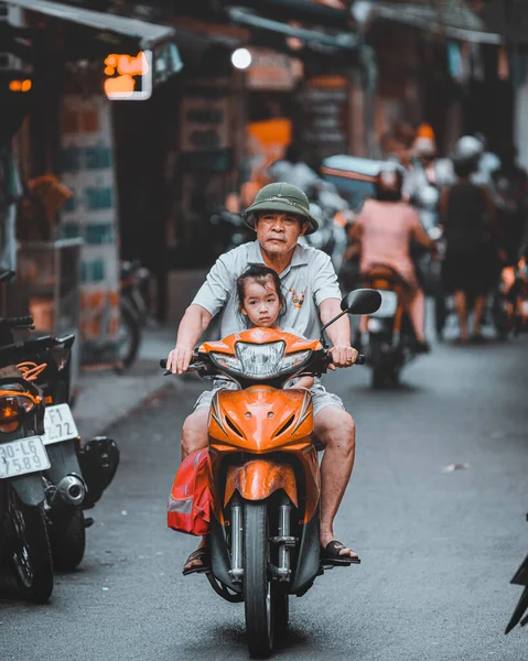 Hanoi, Vietnam - 18th October 209: A father drives daughter to school on a moped in the streets of Hanoi — Stock Photo, Image
