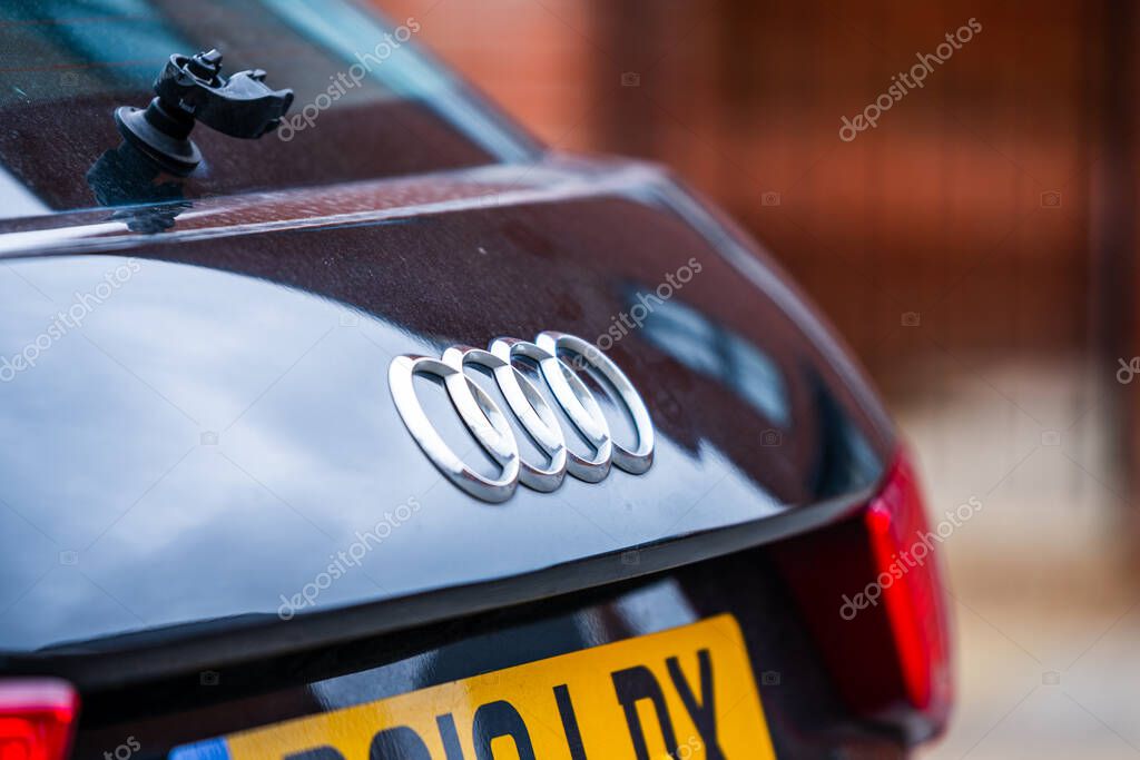Aldershot, UK - 20th July 2020: The famous Audi 4 rings logo on the back of a black car. High quality photo
