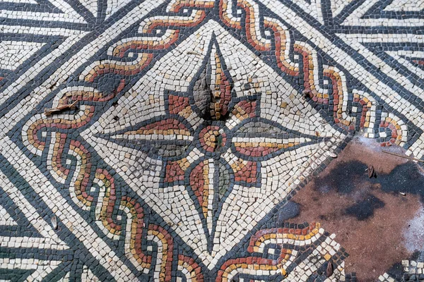 Mozaikové dlaždice z římské vily v západním Sussexu v Anglii. Zobrazuje hvězdu z červených, žlutých, bílých a černých dlaždic — Stock fotografie