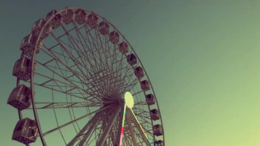 Dönme dolap. Gökyüzüne karşı yüksek atlıkarınca. Yeşil