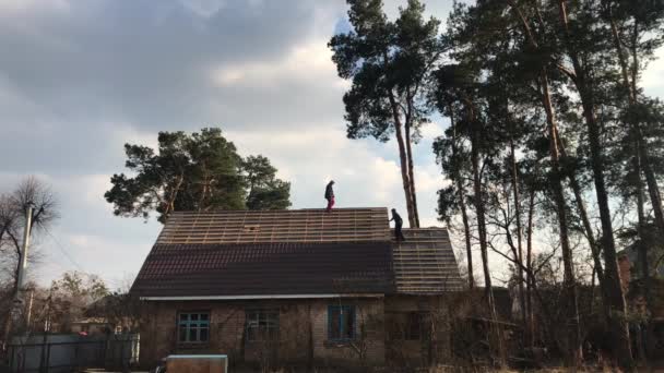 個人の家の屋根の上の男性 労働者を置く屋根 — ストック動画