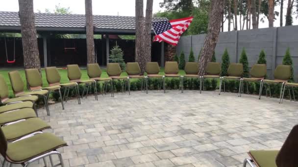 Bahçede Sırtlı Sandalyeler Daire Şeklindedir Bir Amerikan Bayrağı Iki Ağacın — Stok video