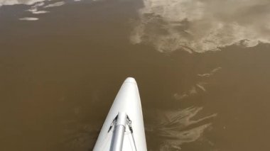 Nehirdeki teknenin ön kısmı. Dinyester Nehri'nin geniş kanyonboyunca bir katamaran üzerinde rafting. Bulutlu hava, güzel manzara.