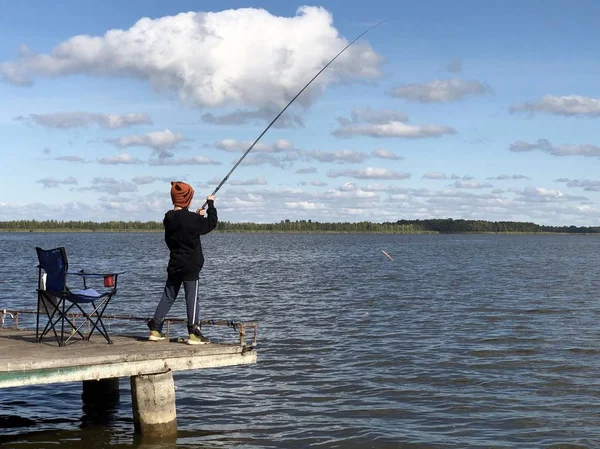 호수에서 낚싯대를 든 소년 이 낚시를 하고 있습니다. — 스톡 사진