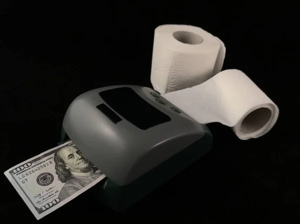 A machine for the production of dollars. Making dollars from toilet paper. Fake American money. Concept: fake dollars, money trash.