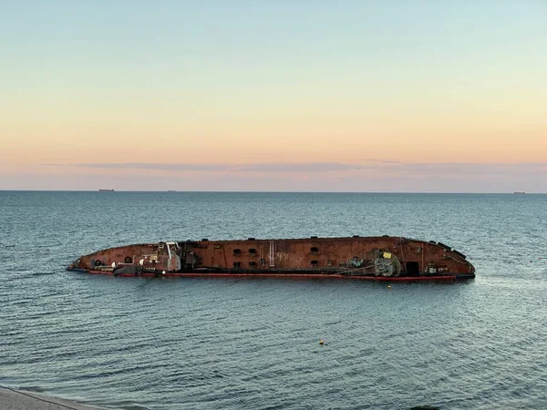 A sunken ship off the Black Sea coast in Odessa. The tanker drowned near Dolphin Beach. Concept: shipwreck, disaster, accident.