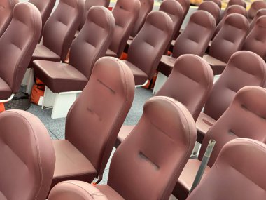 Yumuşak koltuklar sıra sıra dizilir. Turist teknesinde yumuşak koltuklar. Kahverengi koltuklar var. Döşeme kaplanmış deri koltuklar..