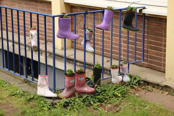gumboots hanging on a fence as decoration