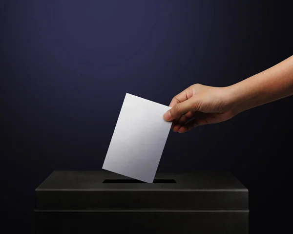 Mão segurando papel de cédula para o conceito de voto eleitoral no fundo da eleição lugar. Vote é muito importante para a nossa nação. Todos fazem o voto — Fotografia de Stock